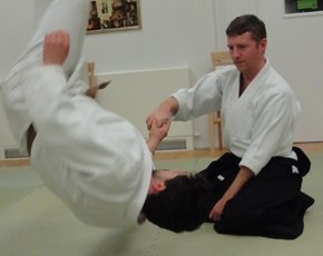 Aikido-James-Knight-seated-throwing-opponent.jpg