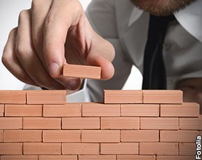 Man building a wall with blocks