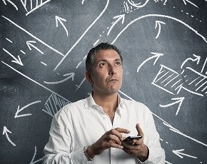 Man in front of chalkboard with directions