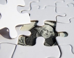 money under puzzle pieces