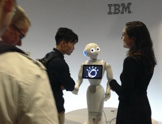 A Pepper robot powered by IBM supercomputer Watson takes questions from conference goers.