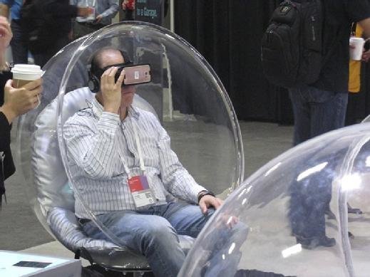 An attendee tries on virtual reality headset at a vendor booth.