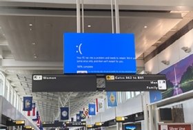 Screenshot of the blue screen of death displayed on Dulles International Airport signage