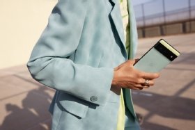 Back of a green Google Pixel 6 smartphone held by a person