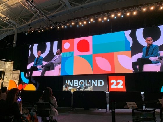 Image of three people sitting on stage at an inbound conference in HubSpot
