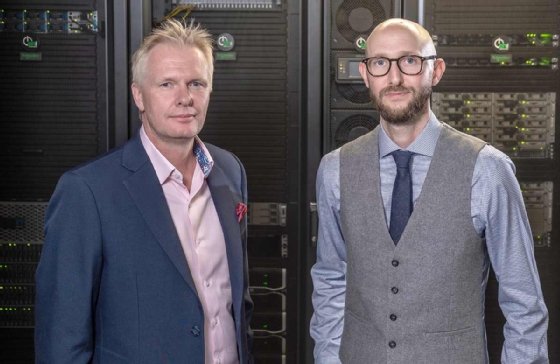 Photo of Tom Jackson and Ian Hodgkinson in a server room. 